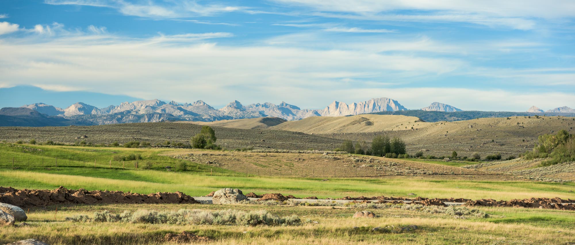 Panorama of the Heart S Ranch Estates meadows with the Wind River Range on the horizon