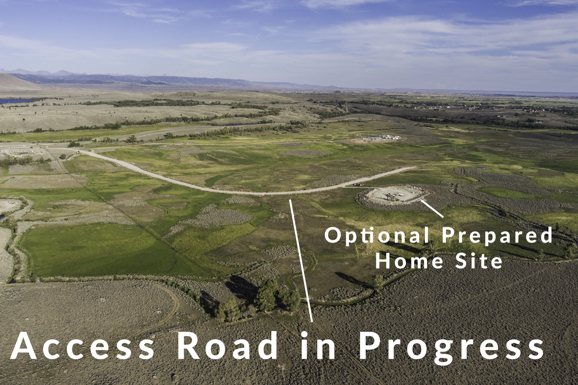 Aerial of Heart S Ranch Estates: the graded access road cutting across the property is labeled "Access Road in Progress," and a prepared building pad is labeled "Optional Prepared Home Site," with the Wind River Range in the distance