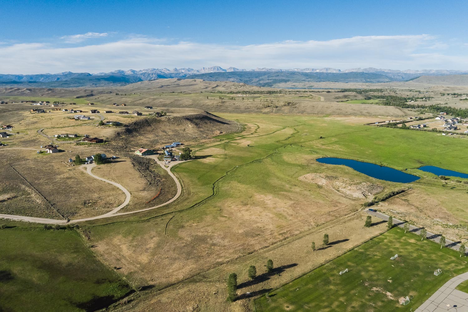 Aerial of the meadow, pond, and roads at the edge of Pinedale